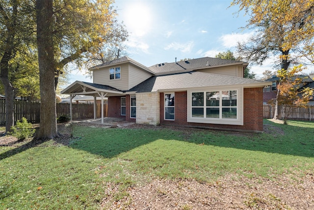 rear view of house with brick siding, a lawn, a fenced backyard, and a patio