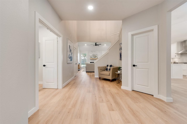 corridor with light hardwood / wood-style flooring