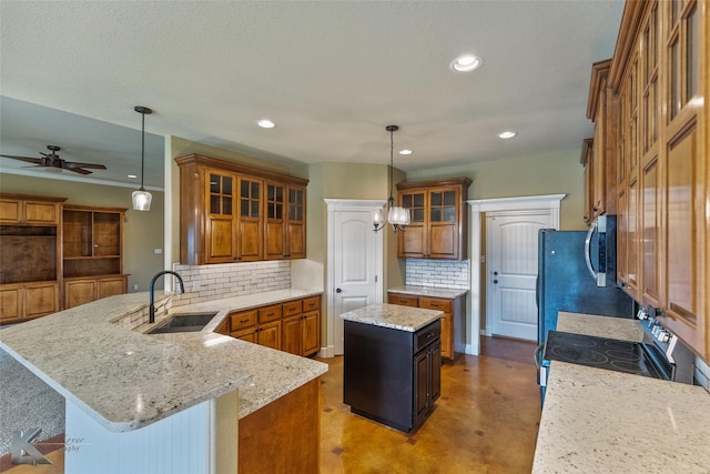 kitchen with backsplash, sink, a kitchen island, and hanging light fixtures