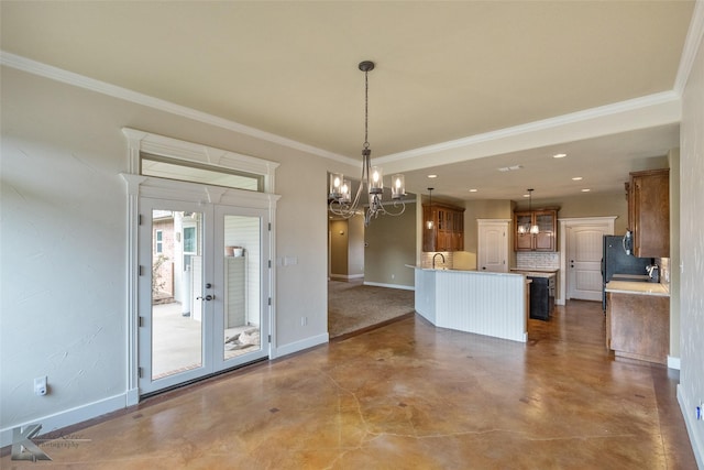 unfurnished dining area with french doors, sink, crown molding, concrete floors, and a notable chandelier