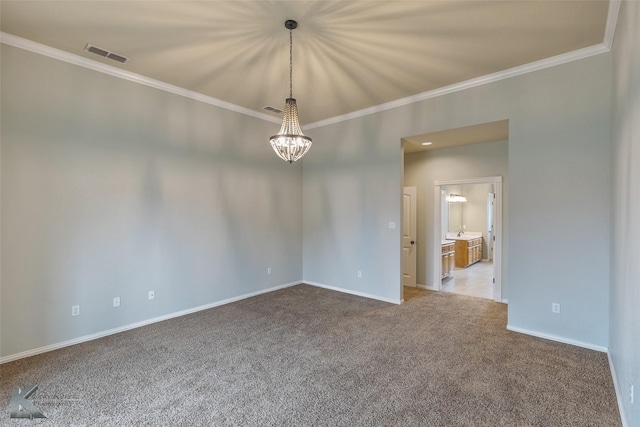 empty room featuring a chandelier, carpet floors, and ornamental molding