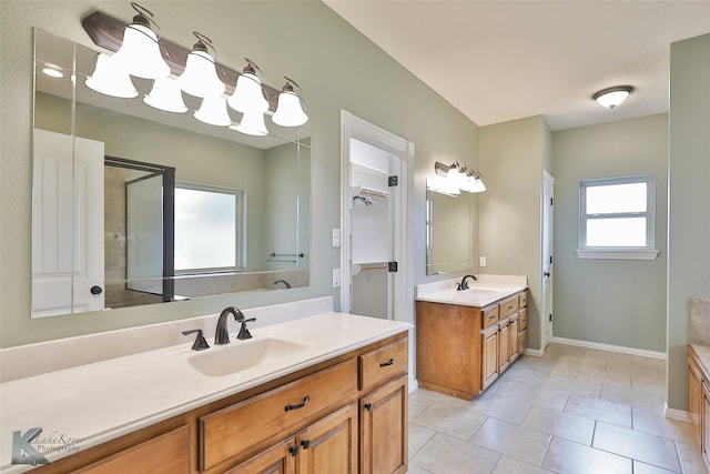 bathroom featuring tile patterned flooring, vanity, and an enclosed shower