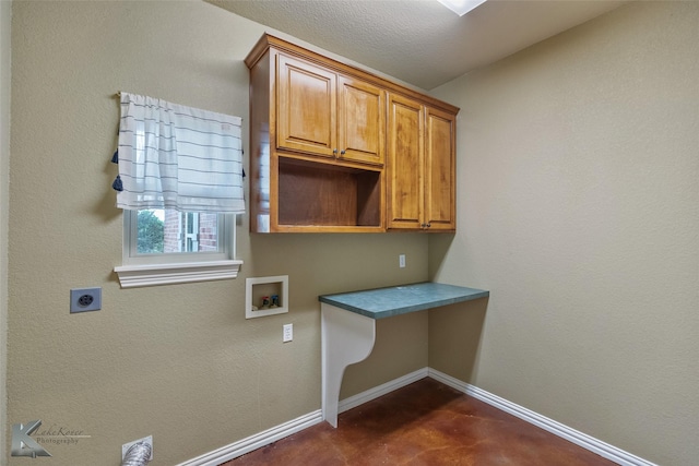 washroom featuring cabinets, hookup for a washing machine, a textured ceiling, and hookup for an electric dryer