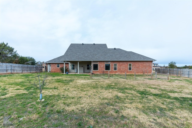 back of house with a yard and a patio area