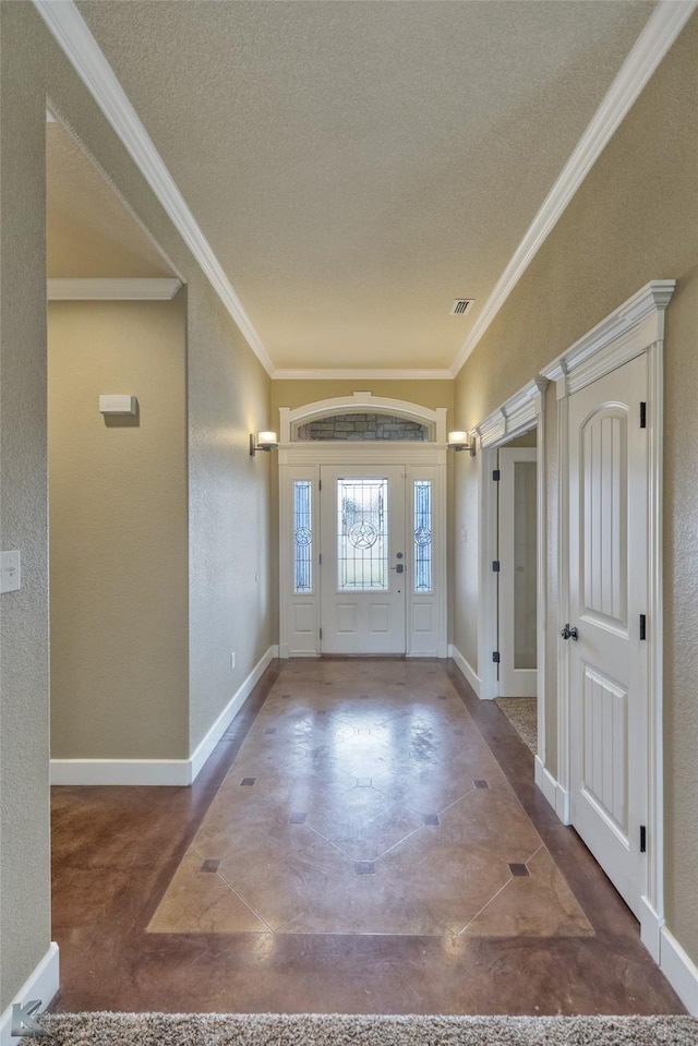 entryway featuring a textured ceiling and crown molding