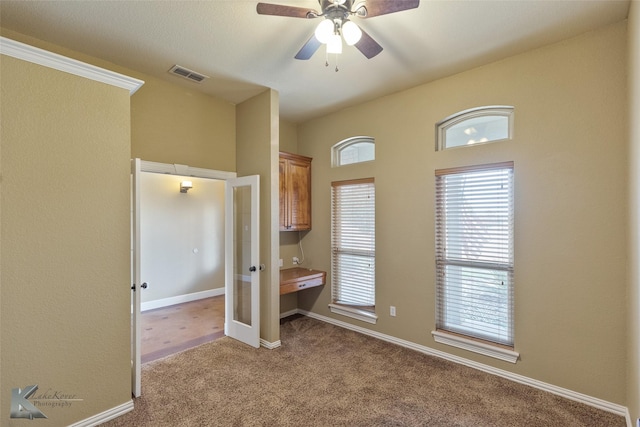 unfurnished bedroom featuring ceiling fan and light carpet