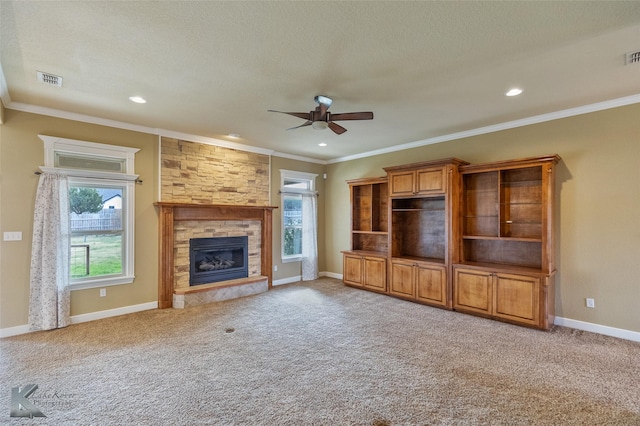 unfurnished living room featuring a stone fireplace and carpet floors