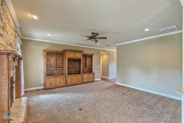 unfurnished living room with crown molding, a fireplace, and light carpet