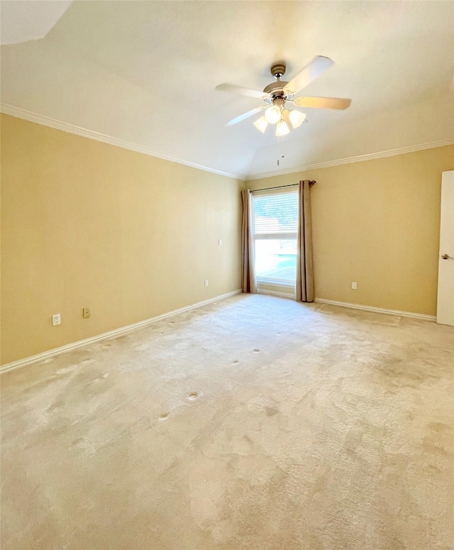 spare room featuring light carpet, lofted ceiling, ceiling fan, and crown molding