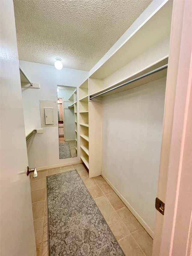 spacious closet featuring light tile patterned floors