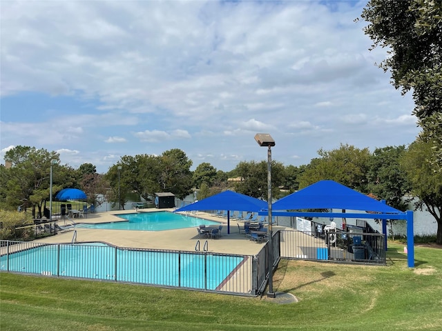 view of pool featuring a yard and a patio