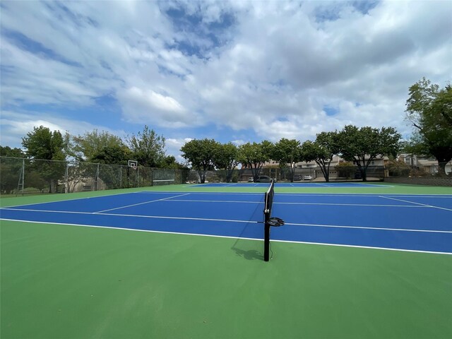 view of sport court with basketball hoop