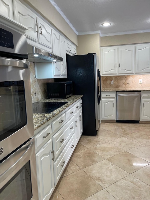 kitchen with white cabinets, backsplash, stainless steel appliances, and light stone counters