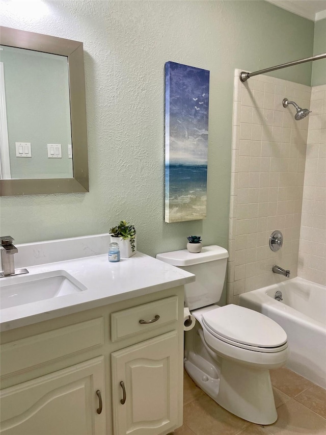 full bathroom featuring toilet, vanity, tile patterned floors, and tiled shower / bath