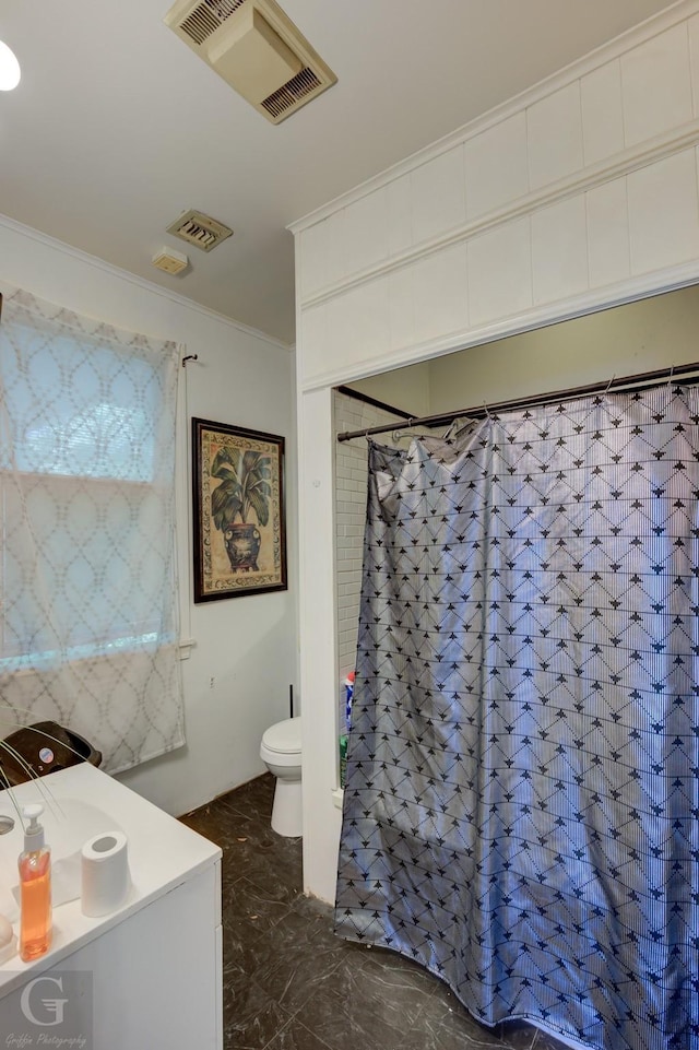 bathroom with toilet and ornamental molding