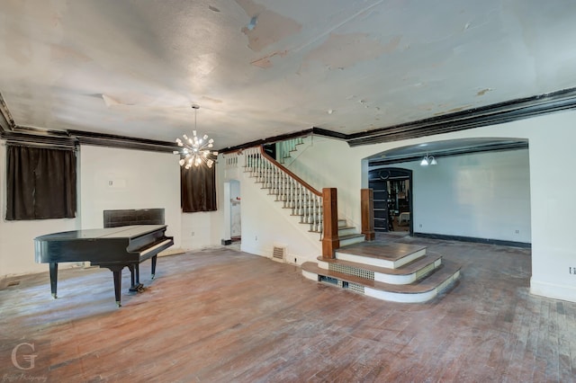 miscellaneous room with crown molding, hardwood / wood-style floors, and a notable chandelier