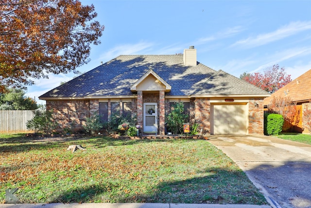 view of front of property with a garage and a front yard