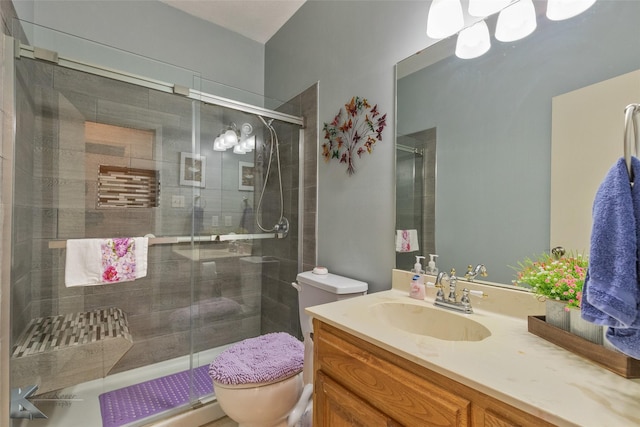 bathroom with vanity, toilet, and an enclosed shower