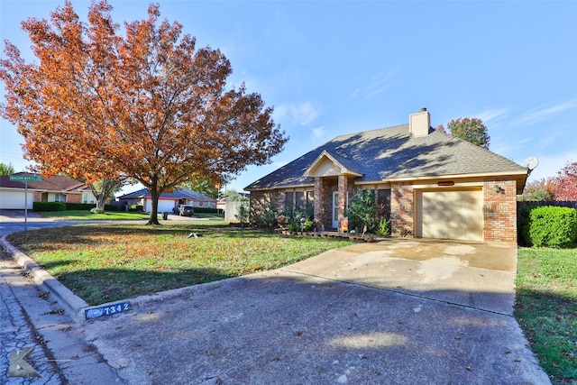 single story home with a front yard and a garage