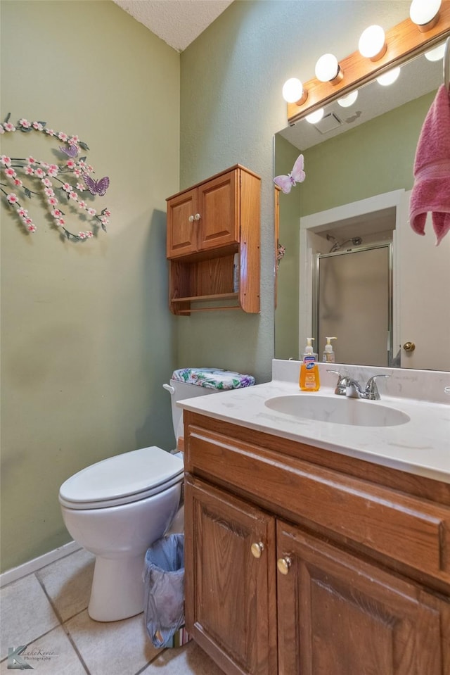 bathroom with walk in shower, tile patterned flooring, a textured ceiling, toilet, and vanity