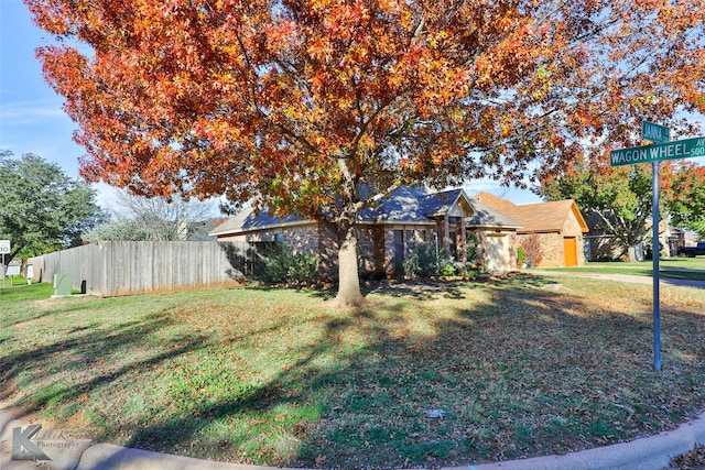 obstructed view of property with a front yard