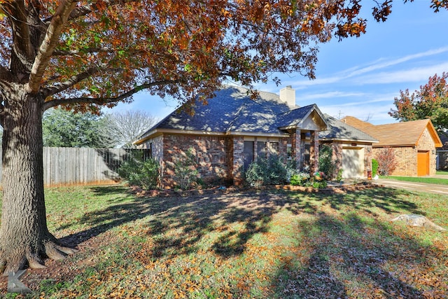 view of front of property with a garage and a front lawn