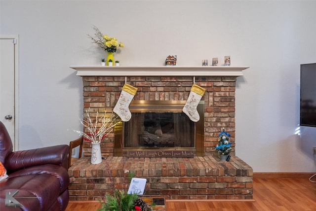 interior details with a fireplace and wood-type flooring