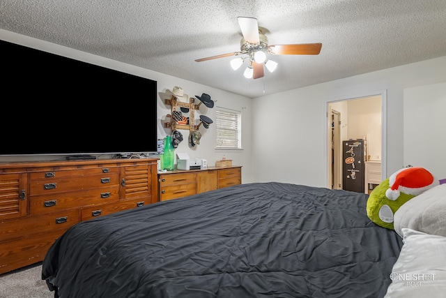 carpeted bedroom featuring ceiling fan, a textured ceiling, and ensuite bath