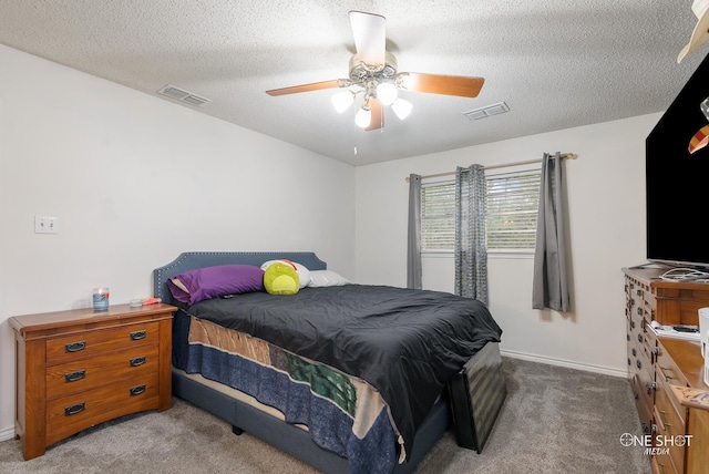 carpeted bedroom featuring a textured ceiling and ceiling fan