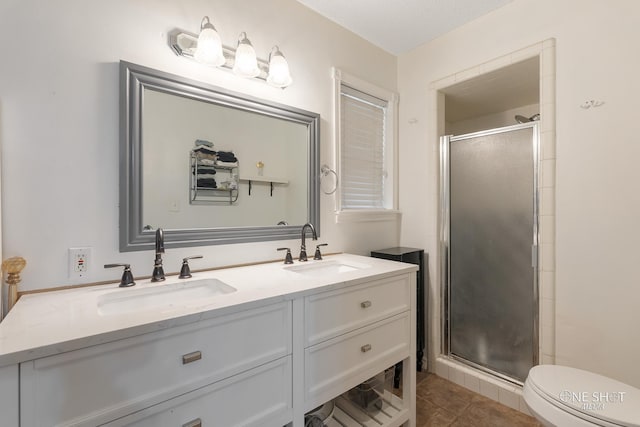 bathroom featuring tile patterned flooring, vanity, an enclosed shower, and toilet