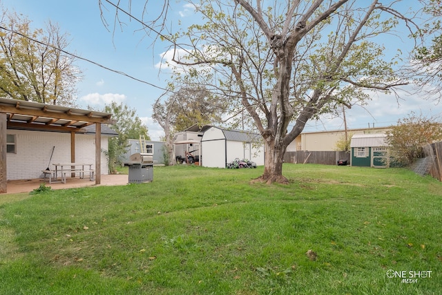 view of yard with a patio area and a storage shed