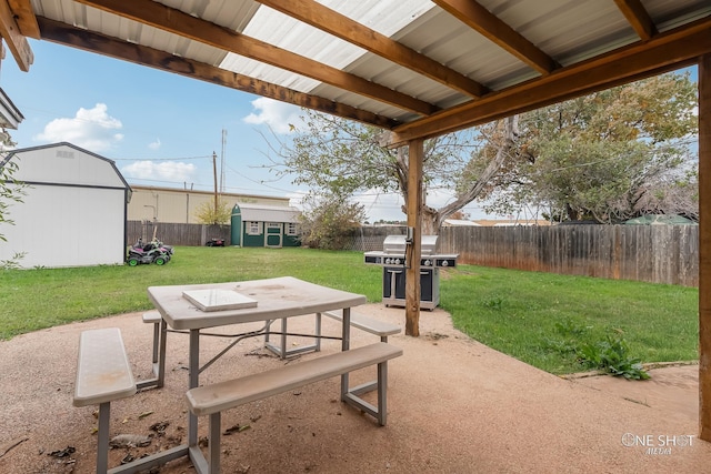 view of patio with area for grilling and a storage shed