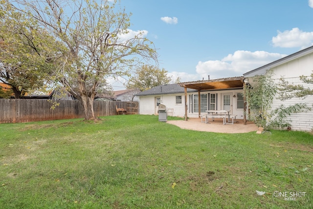 back of house with a lawn and a patio area