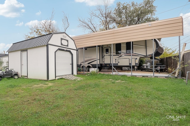 back of house with a yard and an outbuilding