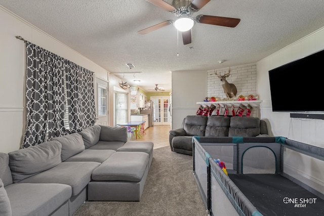 living room with a textured ceiling and light carpet