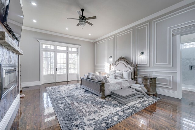 bedroom with french doors, dark hardwood / wood-style floors, ceiling fan, and ornamental molding