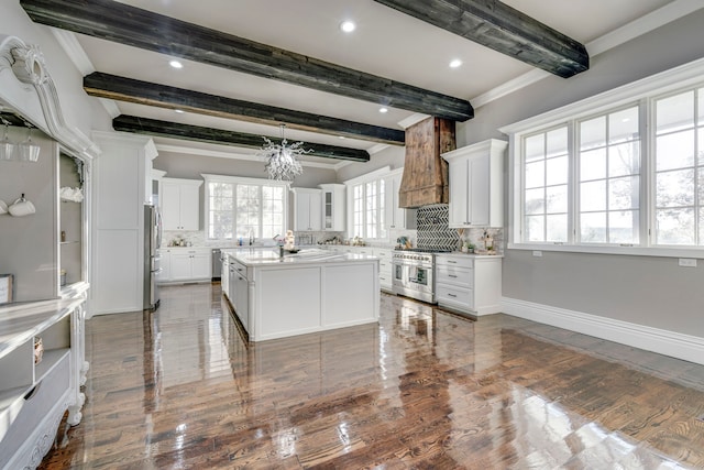 kitchen featuring white cabinetry, stainless steel appliances, and a center island