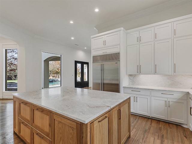 kitchen featuring white cabinetry, plenty of natural light, and built in fridge