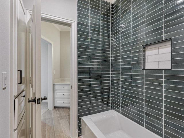 bathroom with hardwood / wood-style flooring and crown molding