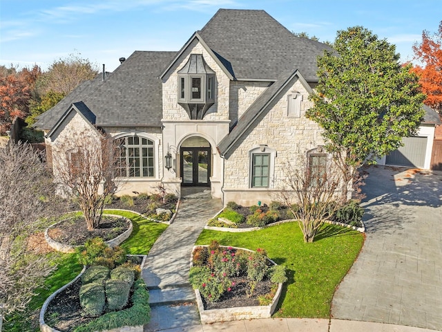 view of front of house featuring a front yard and french doors