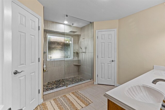 bathroom featuring vanity and a tile shower