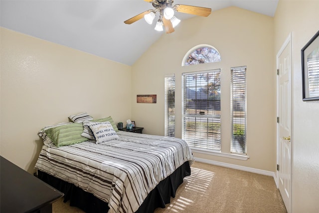 bedroom featuring light colored carpet, vaulted ceiling, and ceiling fan