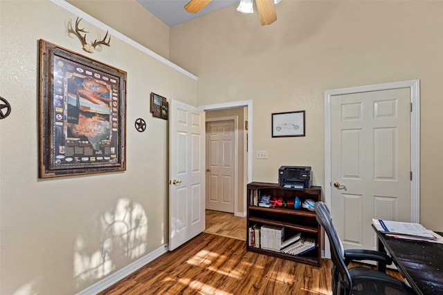 home office with dark hardwood / wood-style floors and ceiling fan