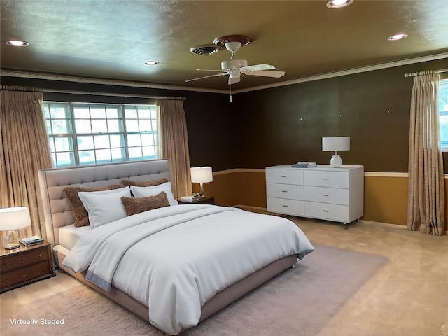 bedroom with light carpet, multiple windows, visible vents, and ornamental molding