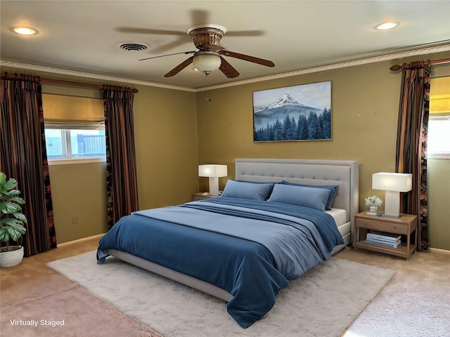 carpeted bedroom with baseboards, a ceiling fan, visible vents, and crown molding