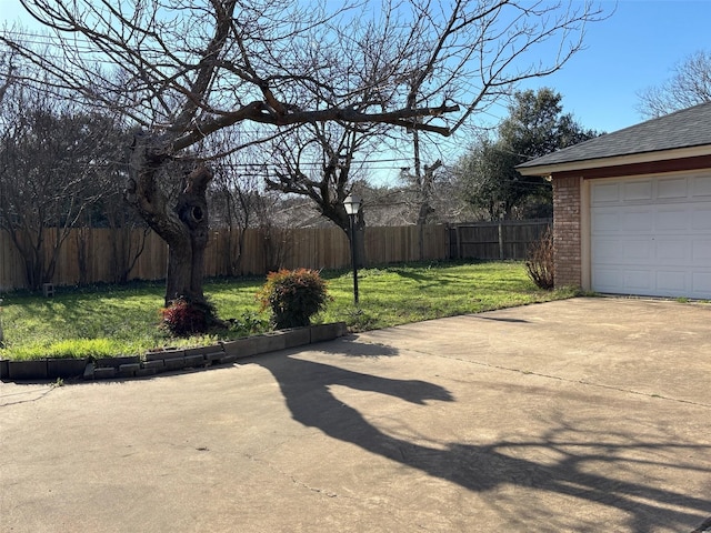 view of yard featuring a garage and fence