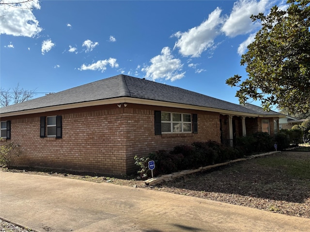 view of side of home featuring brick siding