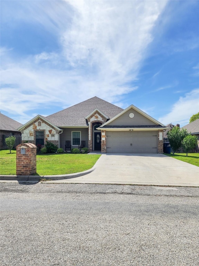 view of front of property with a garage and a front lawn