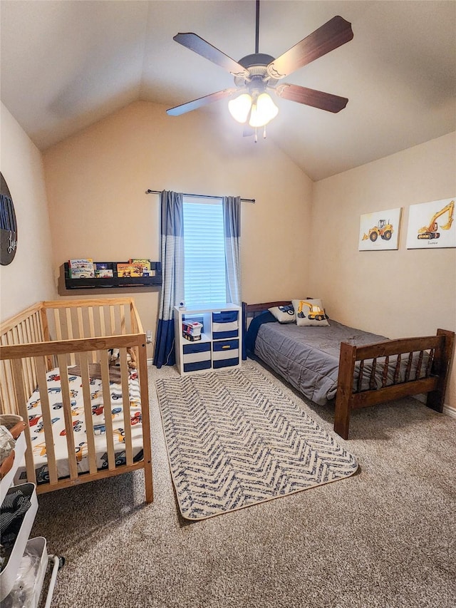 carpeted bedroom featuring ceiling fan and vaulted ceiling