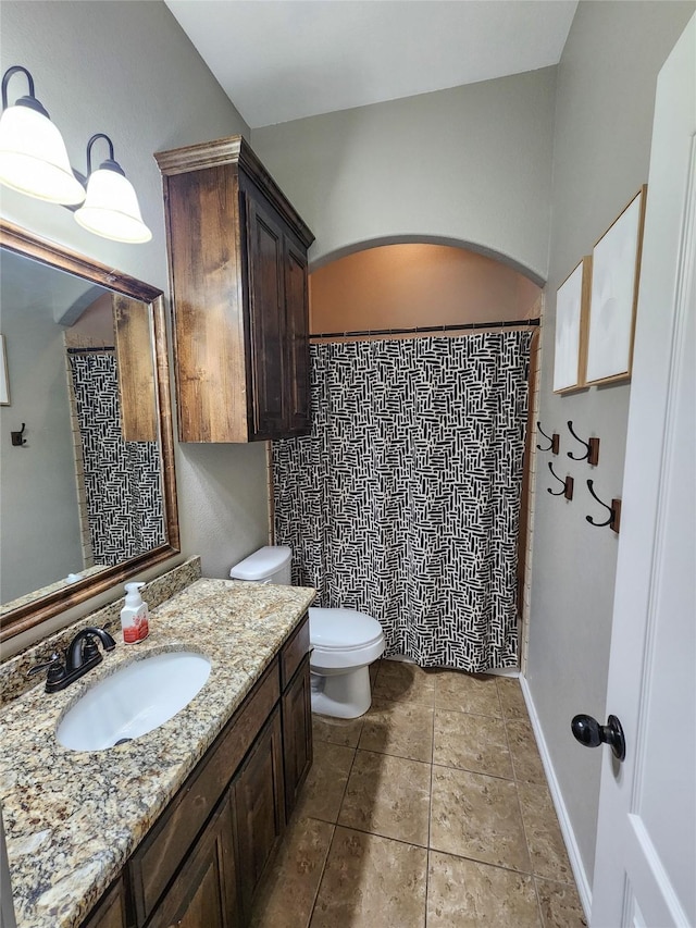 bathroom featuring tile patterned floors, vanity, and toilet